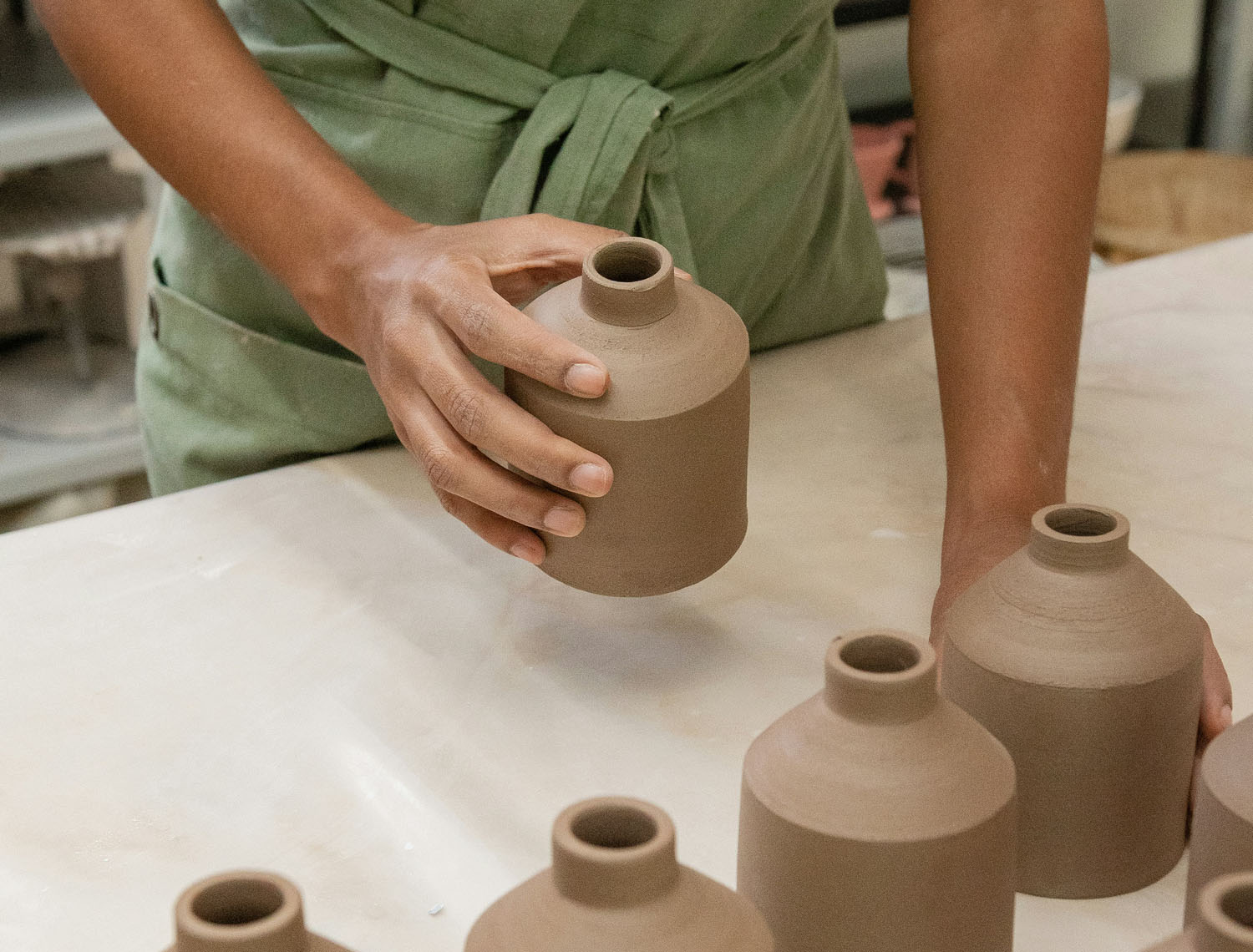 Potter holding ceramic pot